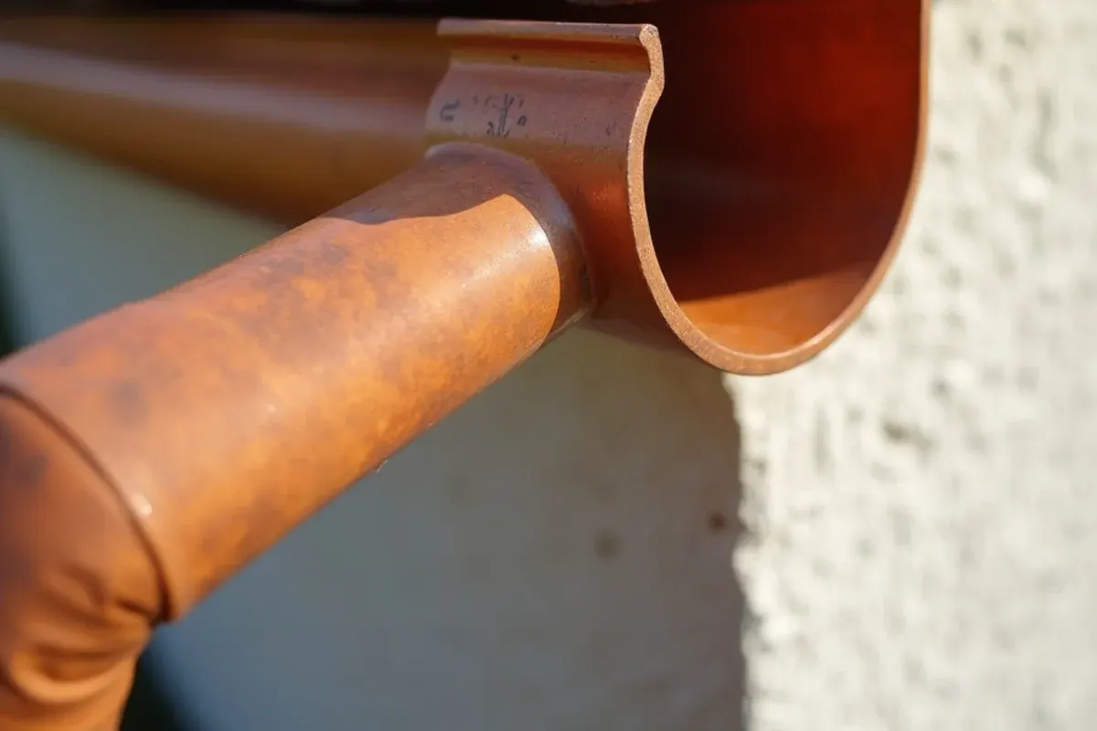 Soldered copper half-round gutter seam with copper hanger and leader head on a coastal home near Riomar in Vero Beach